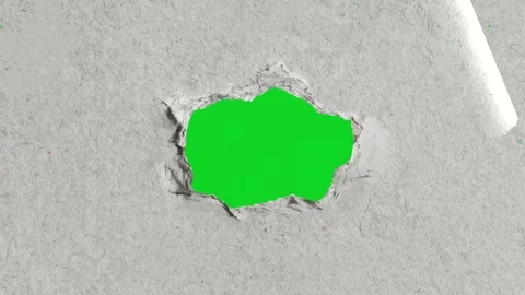 Textured grey paper small jagged torn hole revealing animated on green screen Vidéo 335216381