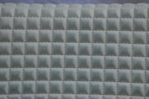 Textured Grid Pattern on a Quilted Surface Foto stock