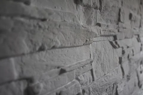 Textured layered stone wall close-up Photos