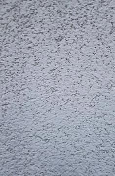 Textured light grey stucco painted wall surface backdrop Stock Photos