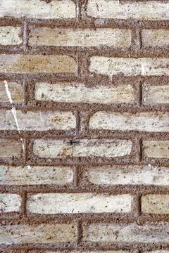 Textured Ochre Brick Wall Background with Thick Mortar Joints Stock Photos