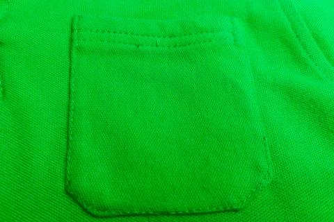 Textured patch pocket on a green polo shirt Stock Photos
