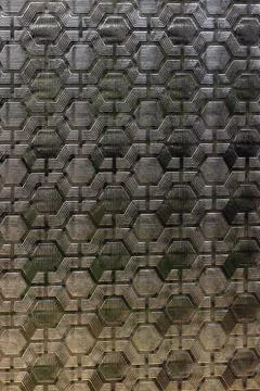 Textured patterned window glass with geometric hexagonal design, abstract b.. Stock Photos