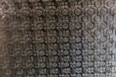 Textured patterned window glass with geometric hexagonal design, abstract b.. Stock Photos