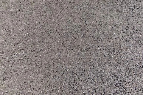 Textured pavement surface with subtle shadow patterns from overhead view Foto stock