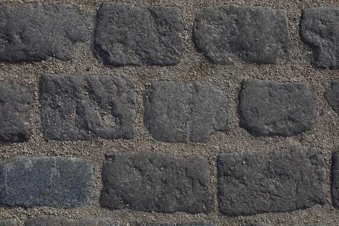 Textured paving brick wall background Stock Photos