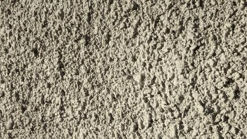 Textured Plaster Wall With an Even Surface Finish Captured in Natural Light Stock Photos