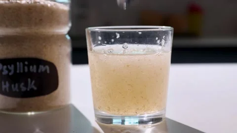 Textured psyllium husk gel forming in water on a kitchen counter Stock Footage 346311112