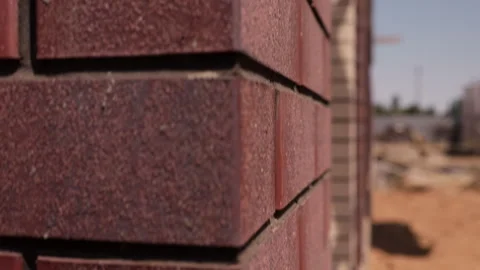 Textured red brick facade corner under construction close up Stock Footage 341985541