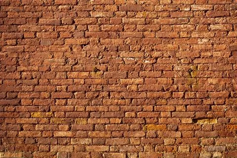 Textured red brick wall in sunlight. background. copy space. Free space for text Stock Photos