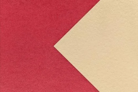 Textured red paper background, half two colors with light beige arrow, macro. Stock Photos
