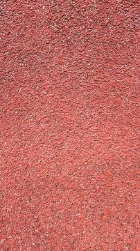 Textured red surface showcasing fine particles and granules in a vibrant an.. Stock Photos
