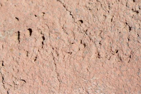 Textured Reddish-Brown Surface with Cracks and Holes Stock Photos
