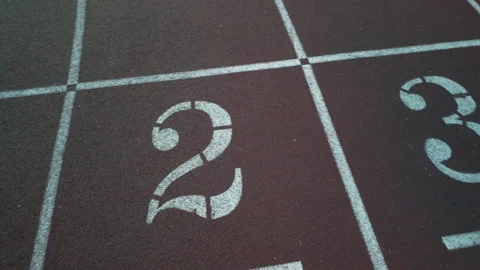 Textured, reddish brown surface of a professional running track Stock Footage 340066908