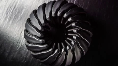 Textured round black object Stock Photos