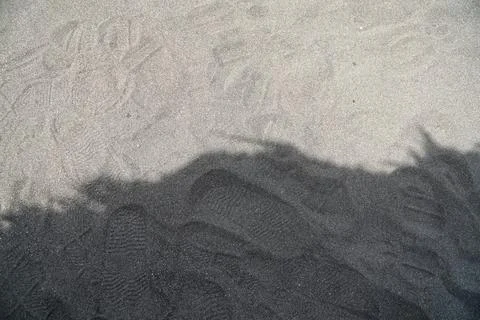 Textured Sand Surface with Contrasting Diagonal Shadow Stock Photos