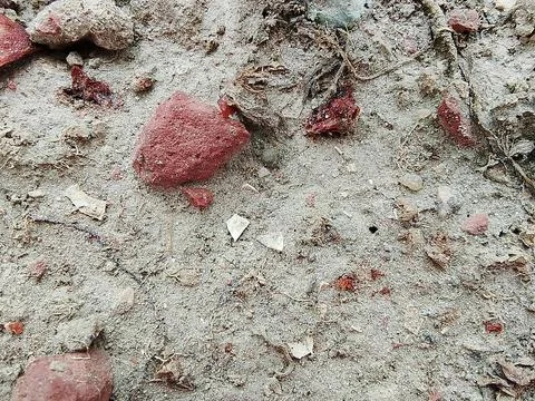 Textured sandy earth surface with red mineral deposits fragment background Stock-Fotos