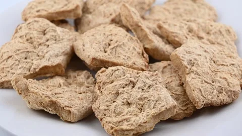 Textured soy chunks piled on white plate in studio kitchen Stock Footage 331591152