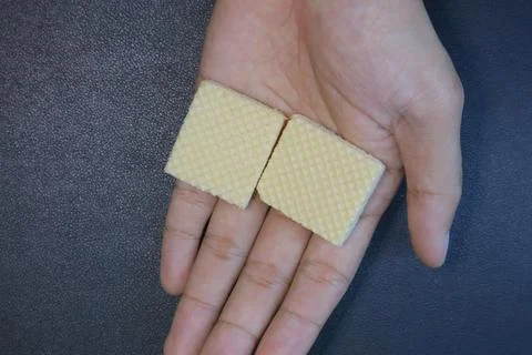 Textured square biscuits on black background Stock Photos