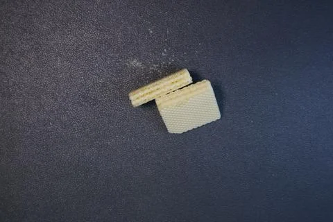 Textured square biscuits on black background Stock Photos