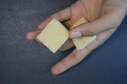 Textured square biscuits on black background Stock Photos