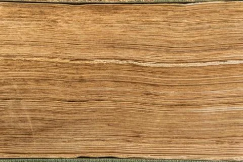 Textured stack of old closed book pages. Close up of old paper pages stack. Stock Photos