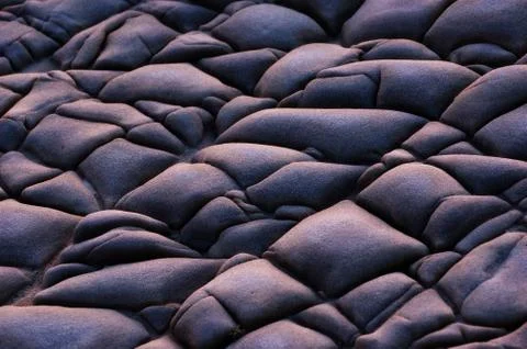 Textured stone formation on beach Stock Photos