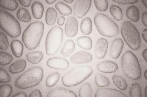 Textured stone wall background with small stones and cement Stock Photos