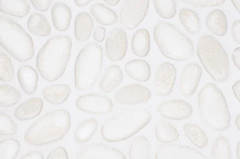 Textured stone wall background with small stones and cement Stock Photos