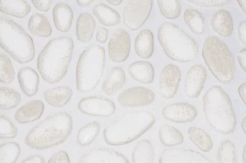 Textured stone wall background with small stones and cement Stock Photos