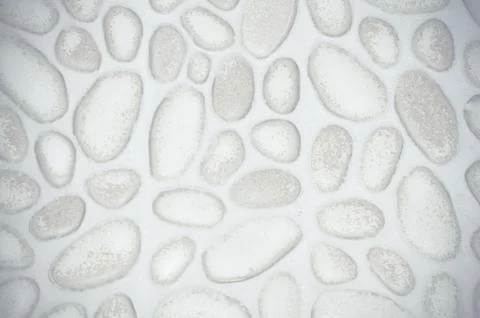 Textured stone wall background with small stones and cement Stock Photos