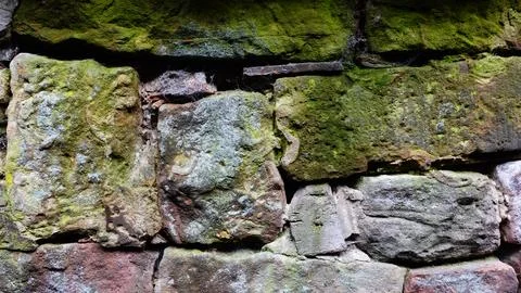 Textured Stone Wall Covered With Moss in a Natural Outdoor Setting Stock Photos