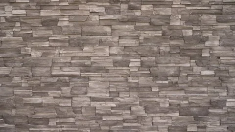 Textured stone wall with layered gray and brown tones Stock Footage 341399701