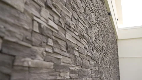 Textured stone wall with natural gray tones and modern architectural detail Stock Footage 341399524