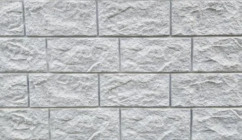  Textured stone wall surface, rough masonry blocks, grey facade constructio Stock Photos