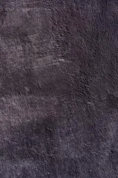 Textured surface in dark gray with visible cracks. Stock Photos