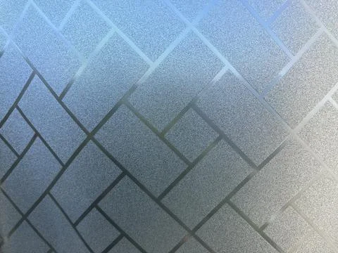 A textured surface featuring a grid pattern. The design includes lines and sh Stock Photos