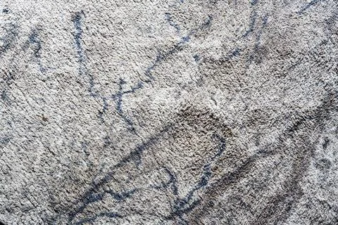 Textured surface of a light-colored carpet with subtle abstract pattern, ideal Stockfoto's