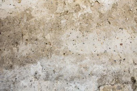 Textured surface of an old, weathered wall with stains and rough patches in Stock Photos