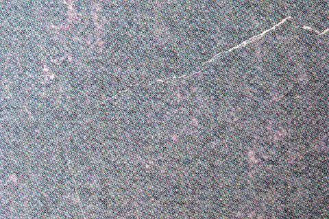 Textured surface reveals a subtle dance of colors and patterns 스톡 사진