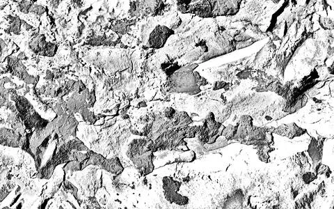 The textured surface of a single-colored rock that is scratched, battered, br Stock Photos