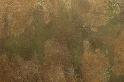 A textured surface with worn coloring appears in the frame. Ochre, green, tan Stock Photos