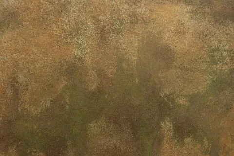 A textured surface with worn coloring appears in the frame. Ochre, green, tan Stock Photos