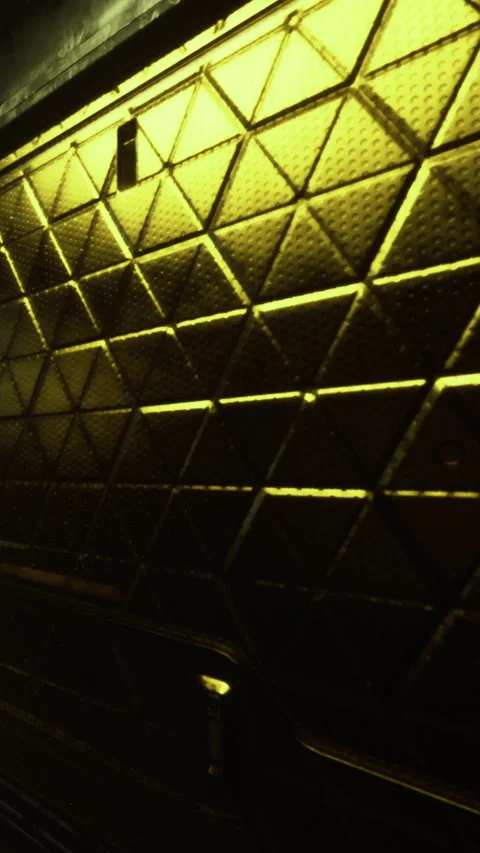 Textured surface with yellow light in a dark setting during evening hours Stock Footage 332210133