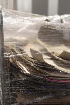 Textured torn cardboard flaps under protective film for creative backgrounds Stock Photos