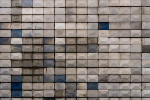 A textured wall composed of repeating concrete blocks in a geometric pattern Stock Photos
