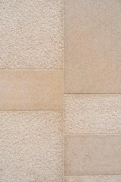 Textured wall divided into distinct sections by visible lines. Left side Foto stock