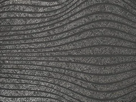 Textured wall facade in the form of silver wavy lines. Stock Photos