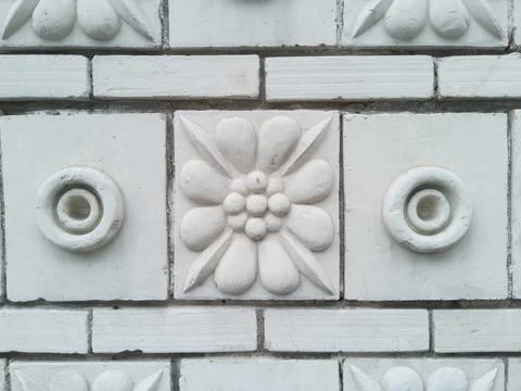 The textured wall is lined with decorative ceramic tiles Stock Photos