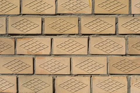 The textured wall is lined with old Soviet beige ceramic tiles. Stock Photos